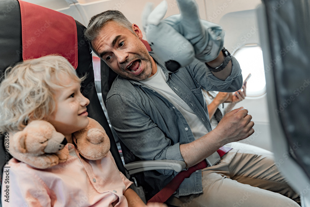 Happy father and son is sitting in plane Happy father and son is sitting in plane