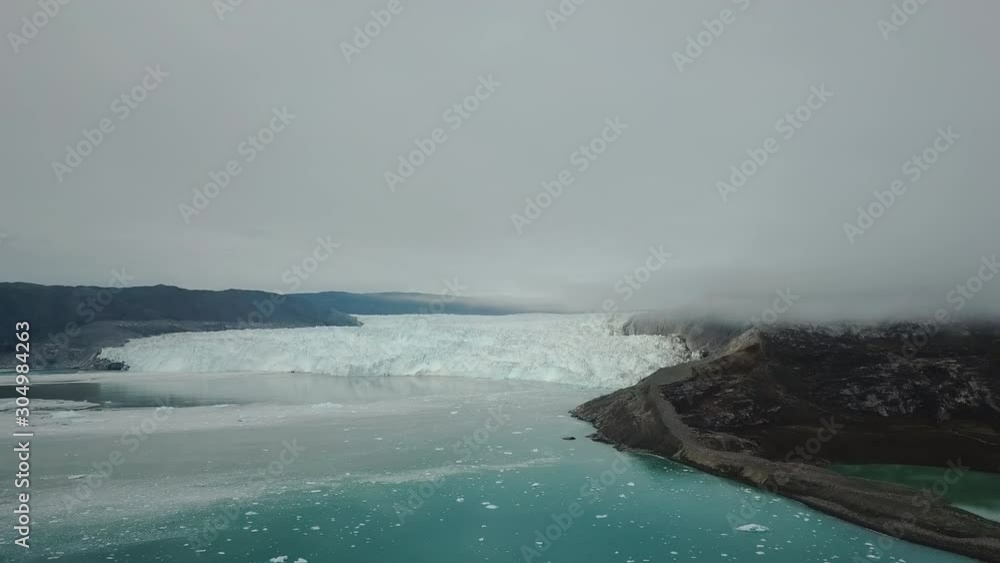 Greenland Aerial Drone flight video at Eqip Sermia, Eqi Glacier in Greenland Disko Bay, Greenland. Also called calving glacier eqi, world heritage, ice breaking of in 4K on an overcast day. Greenland Aerial Drone flight video at Eqip Sermia, Eqi Glacier in Greenland Disko Bay, Greenland. Also called calving glacier eqi, world heritage, ice breaking of in 4K on an overcast day.