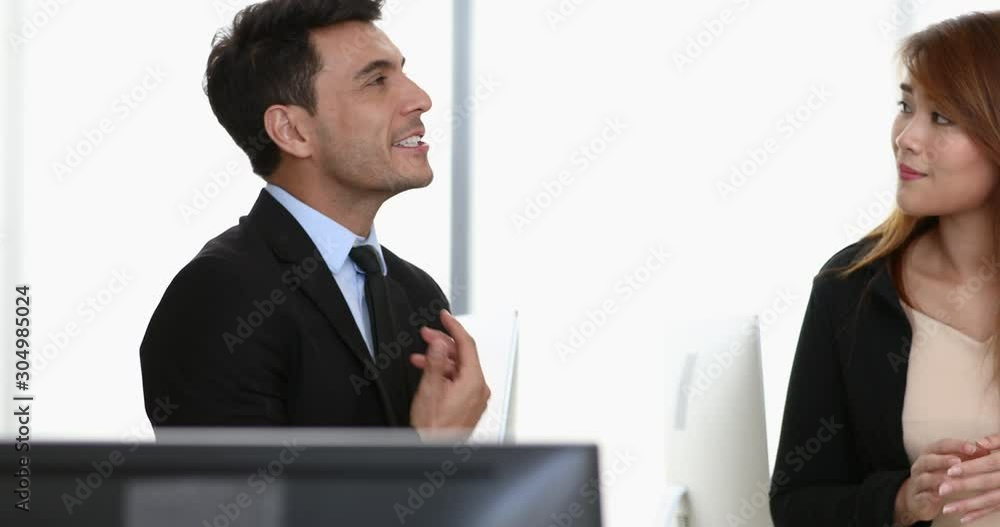 Asian and Caucasian business people sitting on sofa and discussion about the meeting that just passed in modern office. Asian and Caucasian business people sitting on sofa and discussion about the meeting that just passed in modern office.