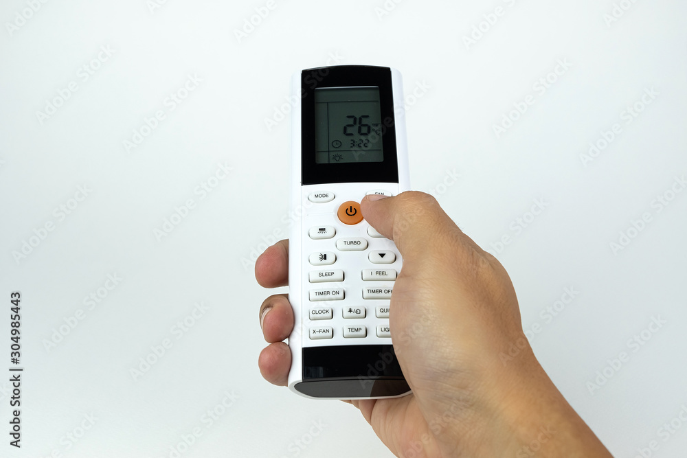 Man hand holding air condition wireless remote control isolated on white background. Man hand holding air condition wireless remote control isolated on white background.