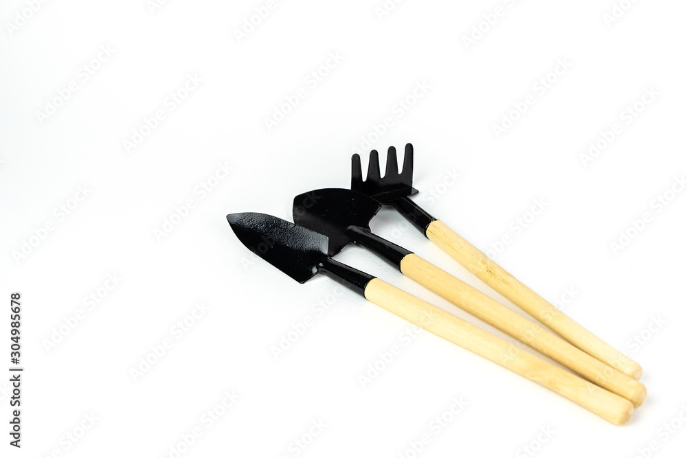 Mini rake and spade for pots gardening. isolated on white background. Close up shot. with copy space.