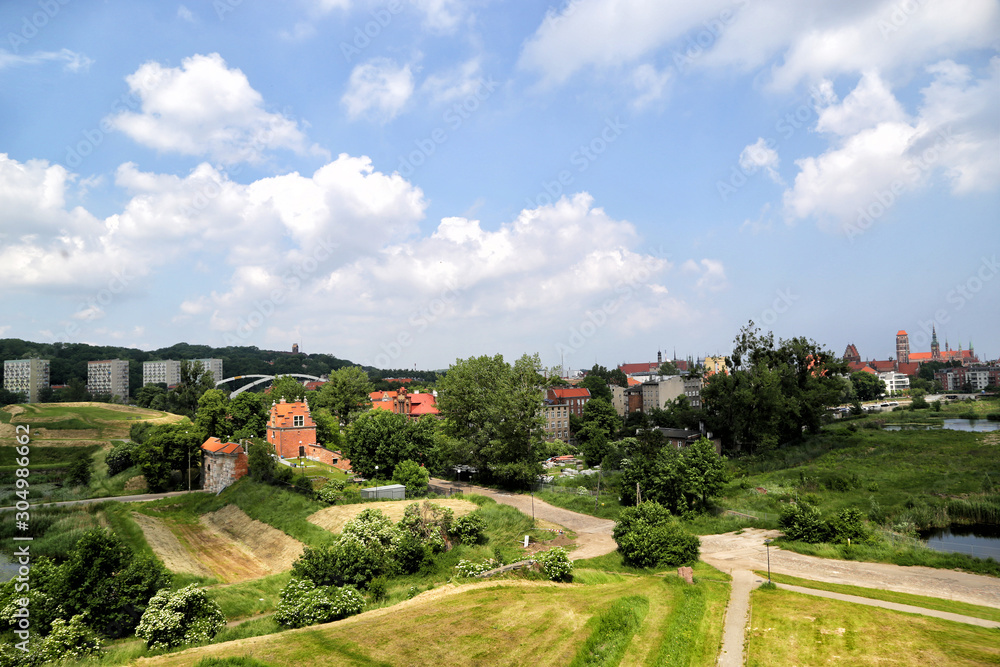 Gdansk, Poland - 06/08/2019: View of the old city gates of Brama Nizinna from a hill in the area of fortifications.