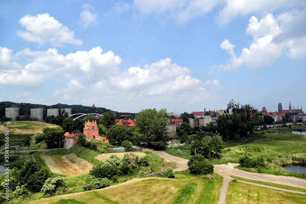 Fototapeta premium Gdansk, Poland - 06/08/2019: View of the old city gates of Brama Nizinna from a hill in the area of fortifications.