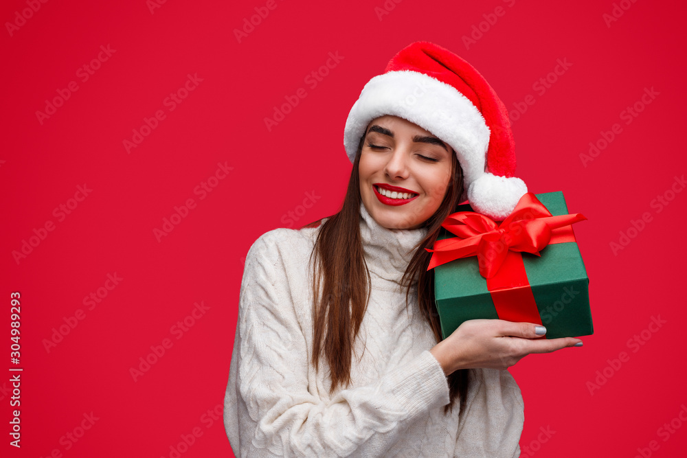 Happy woman guessing Christmas present in box Happy woman guessing Christmas present in box