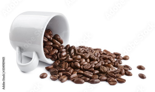 White cup with delicious roasted coffee beans, isolated on white background