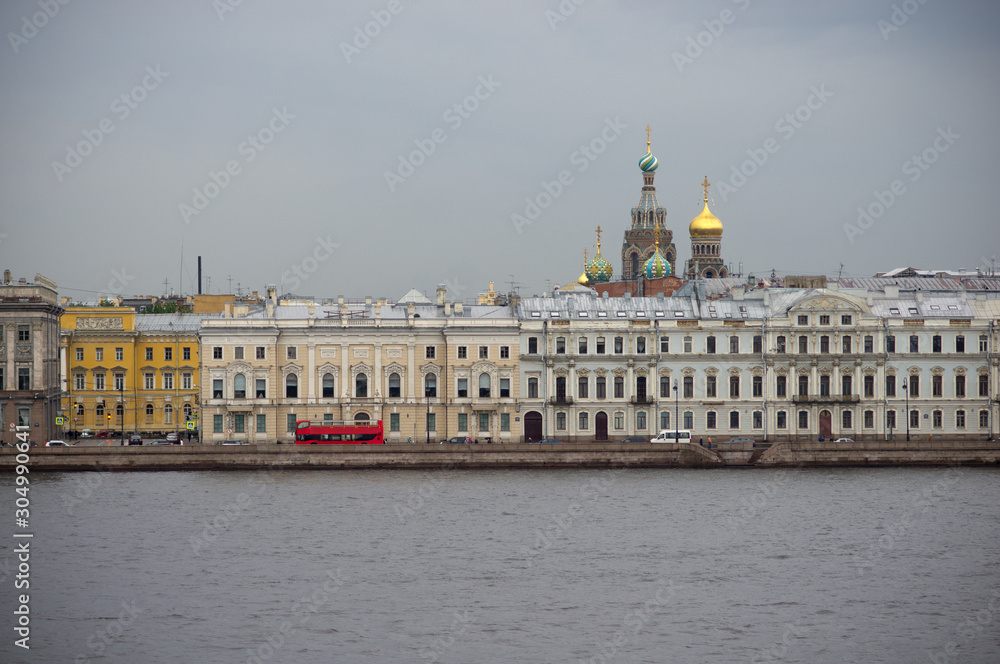 Red touristic bus on an embankment of Neva river, St. Peterburg, Russia