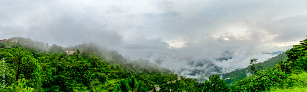 The clouds and the mountain range while driving to Binsar, near Almora, Uttarakhand- lush green vegetation all around, rainy season, monsoon India