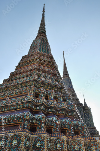 The towers of the ancient Buddhist monastery are decorated with colorful patterns. photo