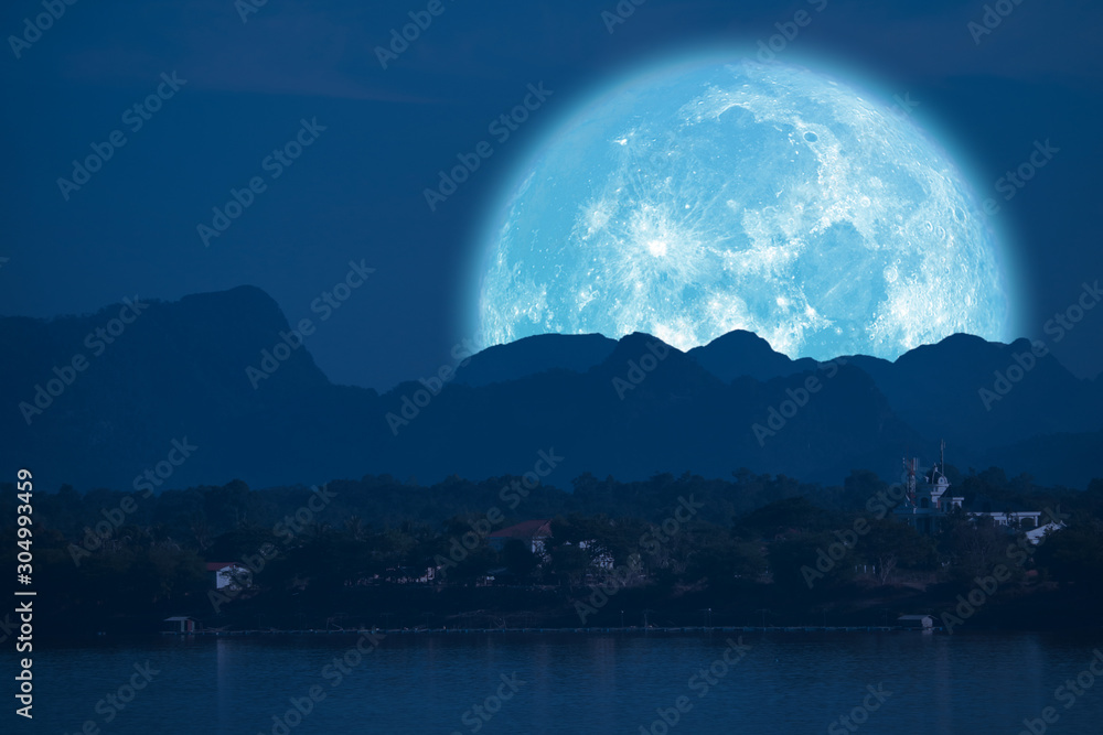 full Beaver Moon back on mountain and reflection on river in the night sky