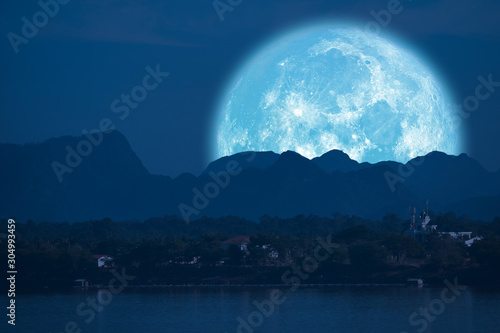 full Beaver Moon back on mountain and reflection on river in the night sky