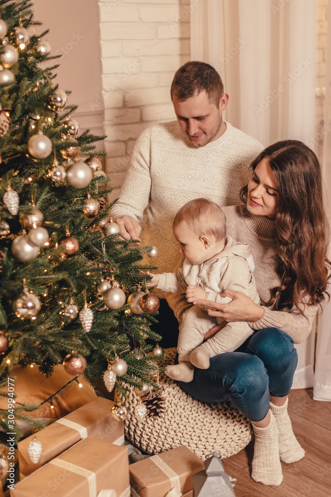 Happy family decorating Christmas tree and celebrating new year together. Celebrating Christmas.