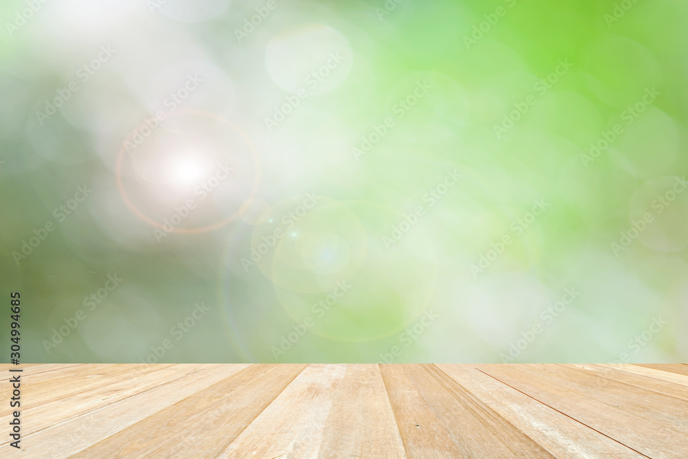 Empty top wooden table on spring nature green blur background Empty top wooden table on spring nature green blur background