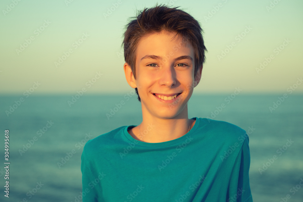 Handsome young boy at beach. Beautiful calm smiling teen boy at Mediterranean sea coast. Travel, summer vacation, tourism, teenage lifestyle. Handsome young boy at beach. Beautiful calm smiling teen boy at Mediterranean sea coast. Travel, summer vacation, tourism, teenage lifestyle.
