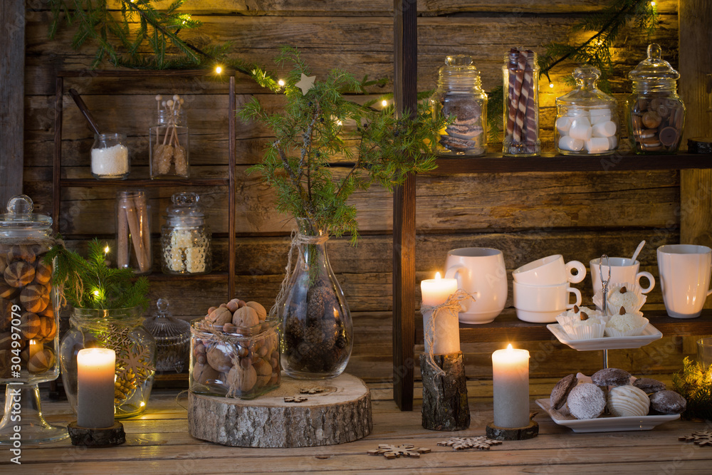 Fototapeta premium Christmas decoration cocoa bar with cookies and sweets on old wooden background in natural rustic style. Winter cozy concept