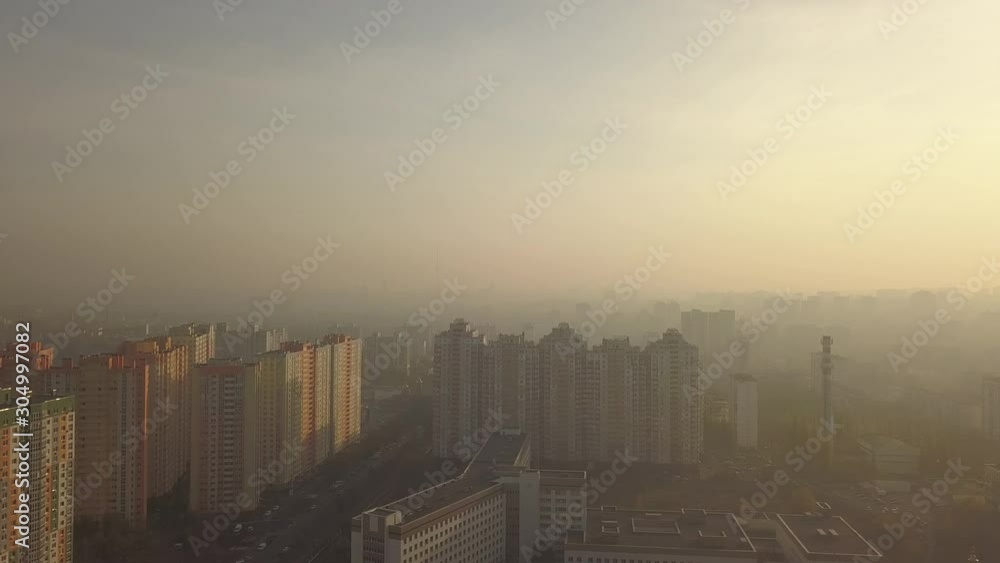 Panoramic view of the metropolis with apartments, buildings and streets smoggy at sunset. Aerial view. Air pollution in the city. Outskirts of the capital of Ukraine Kiev Panoramic view of the metropolis with apartments, buildings and streets smoggy at sunset. Aerial view. Air pollution in the city. Outskirts of the capital of Ukraine Kiev