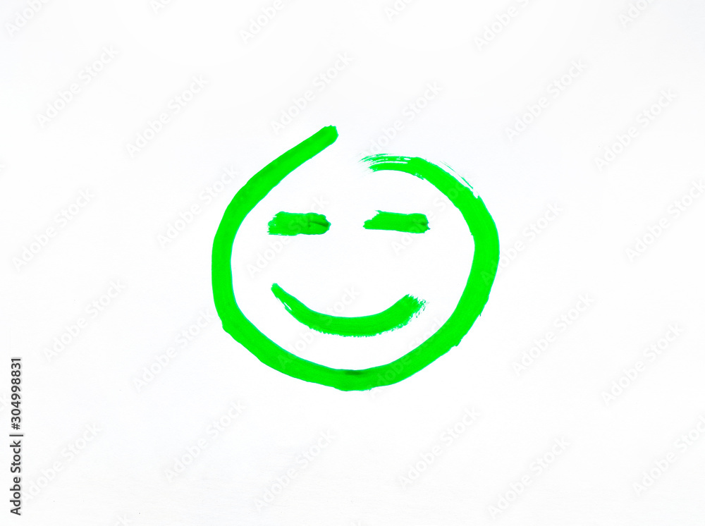 Smiley face with a smile painted on paper. Joyful and smiling smiley green painted with gouache and brush. Smiley face with a smile painted on paper. Joyful and smiling smiley green painted with gouache and brush.