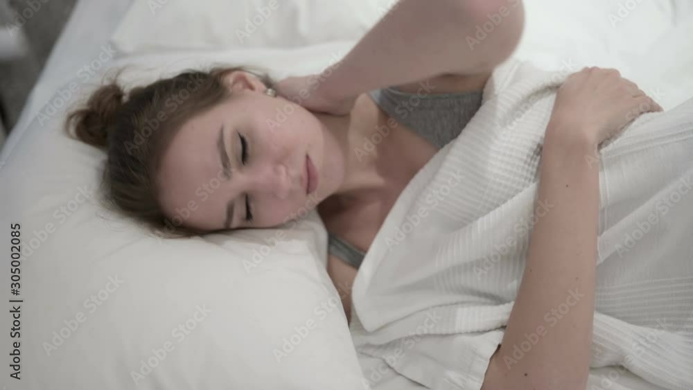 Sleeping Young Woman having Neck Pain in Bed Sleeping Young Woman having Neck Pain in Bed