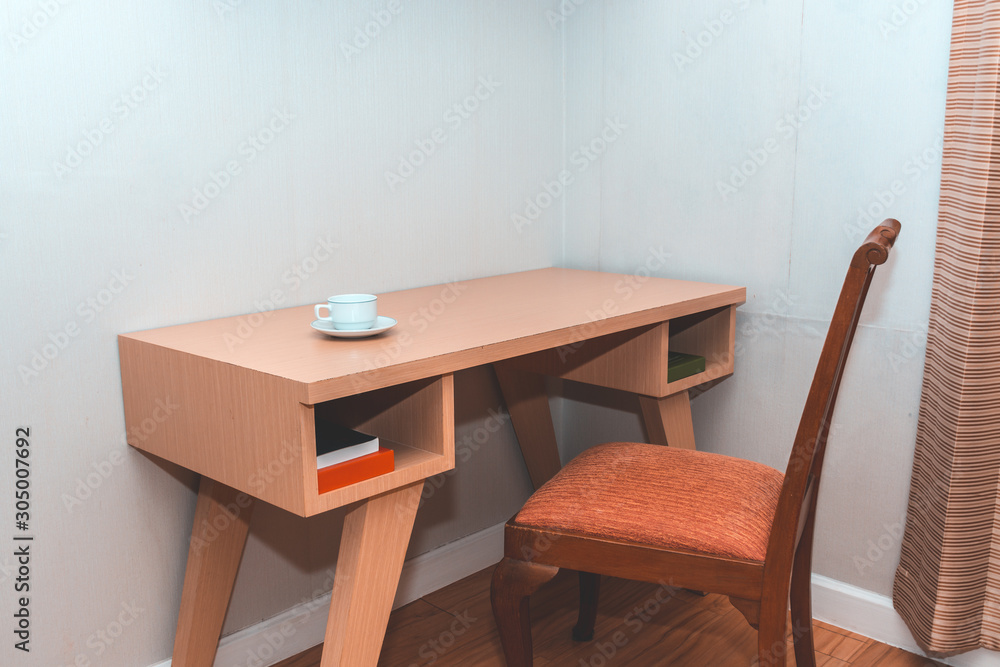 Coffee cup on desk in room corner. Coffee cup on desk in room corner.