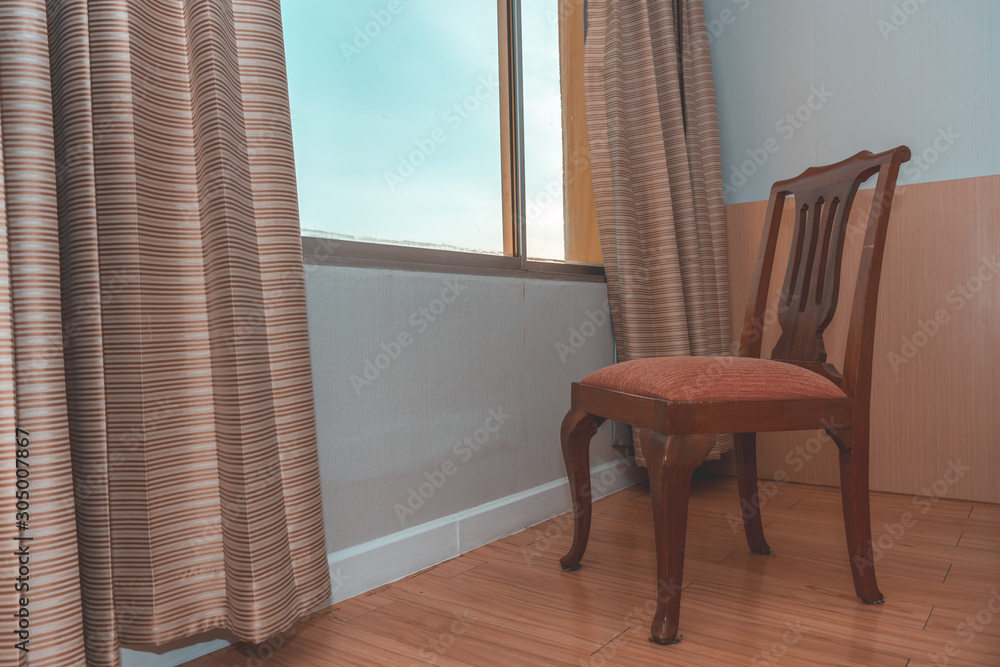 Fototapeta premium A chair near glass window