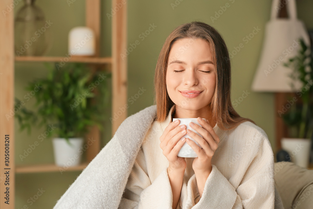 Young woman with cup of hot tea resting at home Young woman with cup of hot tea resting at home