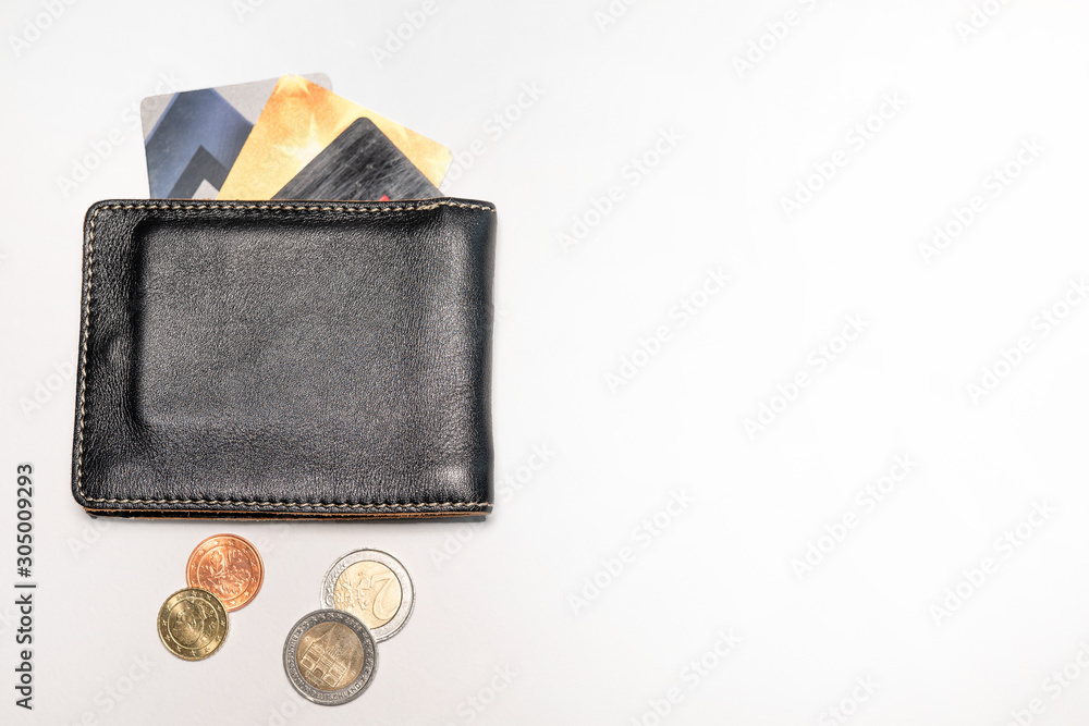 Leather wallet, with Euro coins and credit or debit cards, on a white background