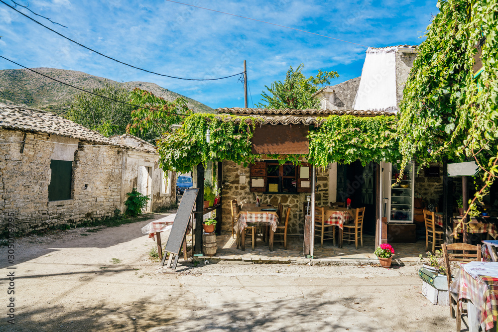 Main square with cafeterias and tavernas in abandoned village Old Perithia Main square with cafeterias and tavernas in abandoned village Old Perithia