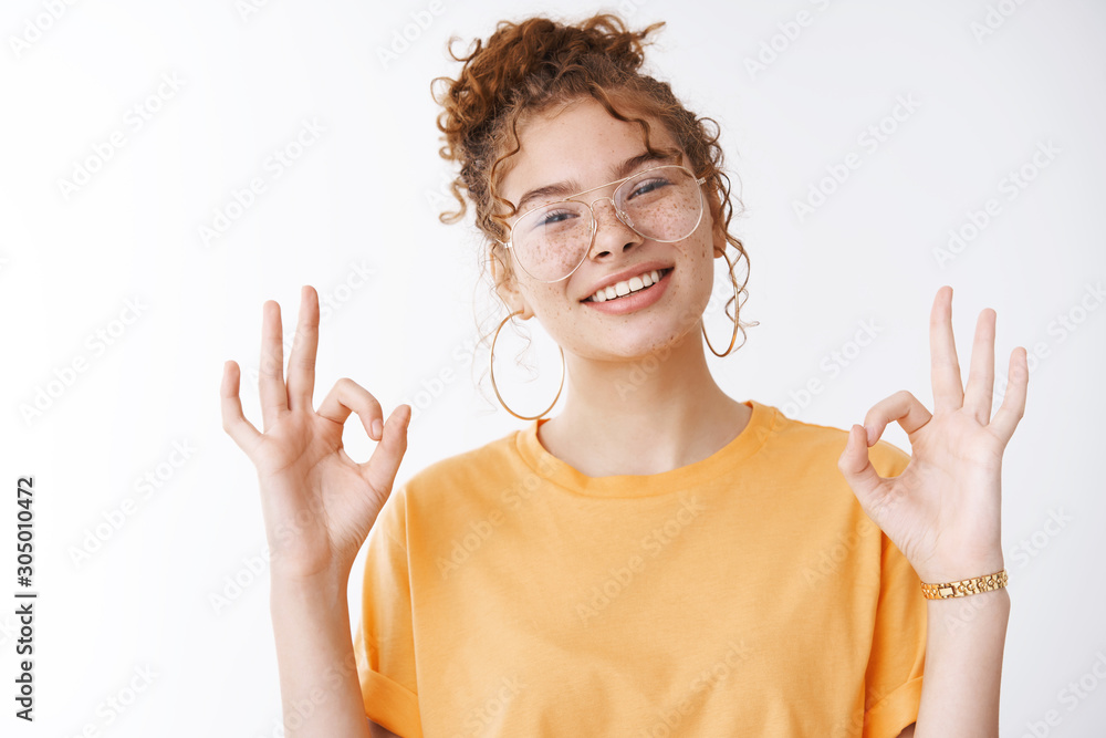 Everything super. Portrait charming chill confident happy smiling redhead  girl wearing glasses orange t-shirt tilting head grinning self-assured show  okay ok no problem gesture white background Photos | Adobe Stock