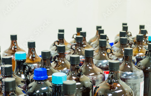Obraz na plátně The many of amber glass bottle contains chemical hazardous waste from the labora