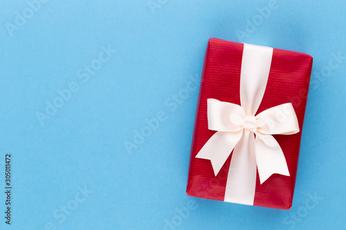 Christmas gift boxes with ribbons on color tabletop. © gitusik
