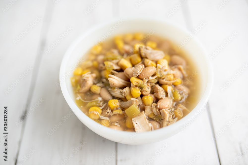 Flavorful White Chicken Chili made with hearty beans, tender chicken, and a rich and creamy broth in slow cooker Flavorful White Chicken Chili made with hearty beans, tender chicken, and a rich and creamy broth in slow cooker