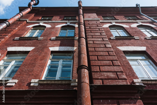 Bottom view of a beautiful red brick building. The architecture of past centuries.
