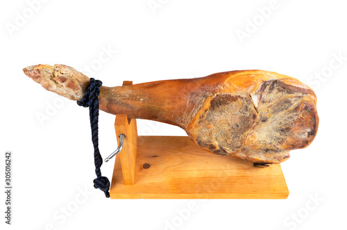 Jamon serrano. A Spanish ham isolated on white background. Traditional spanish jamon serrano leg isolated. Dry cured meat ham. Whole leg. Jamon on jamonero stand