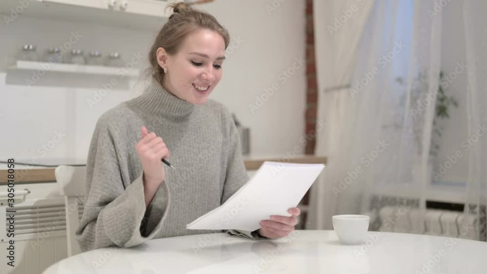 Successful Woman reading Documents and Celebrating Successful Woman reading Documents and Celebrating