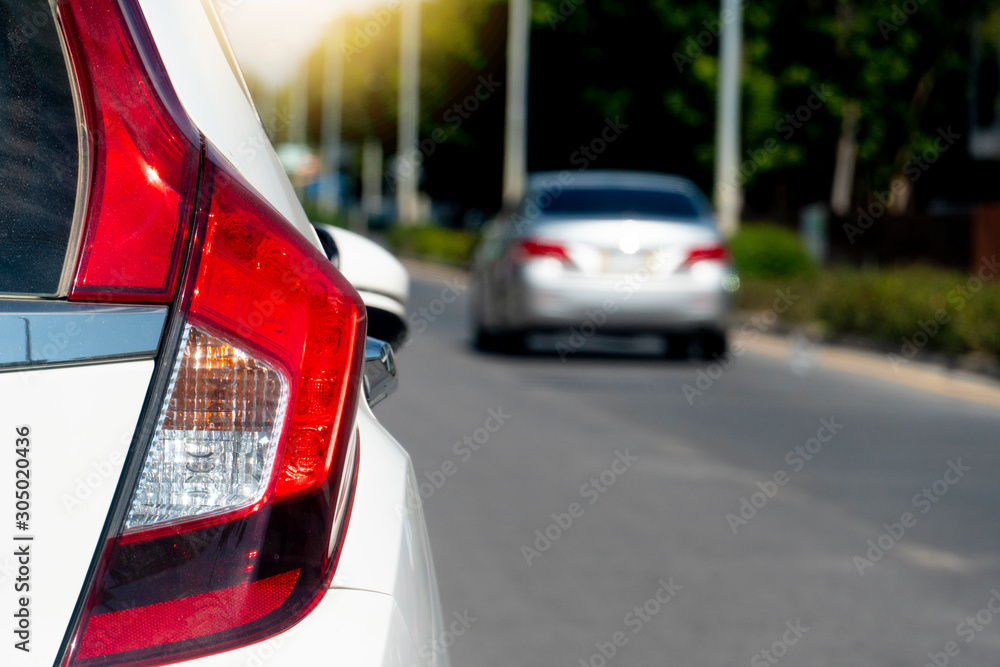 Luxury of white car stop on the concrete road. Traveling in the provinces during the bright period. with other drive on the road. Luxury of white car stop on the concrete road. Traveling in the provinces during the bright period. with other drive on the road.