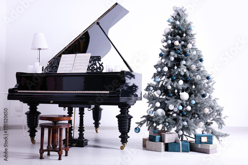 Grand piano in room decorated for Christmas photo