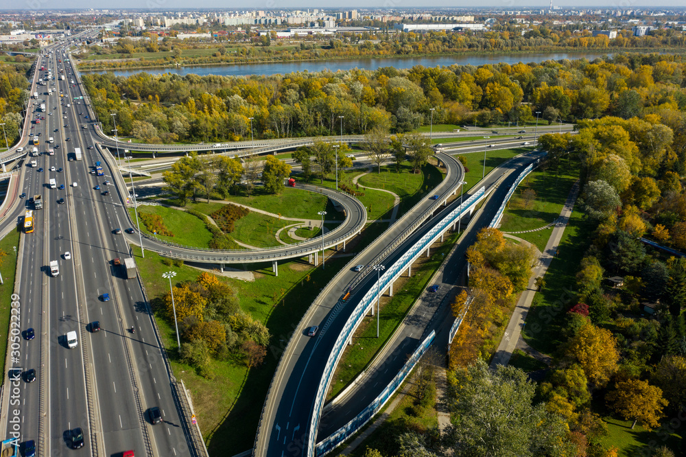 Aerial shot of  big freeway intersection in Warsaw, traffic going fast through many road flyovers. Aerial view of a motorway with several traffic intersections in Warsaw, 