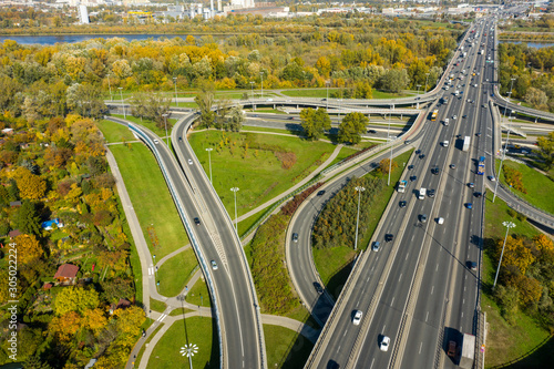 Aerial shot of a big freeway intersection in Warsaw, traffic going fast through many road flyovers. Warsaw, Poland. 