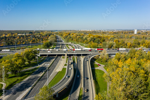 Aerial shot of a big freeway intersection in Warsaw, traffic going fast through many road flyovers. Warsaw, Poland. 