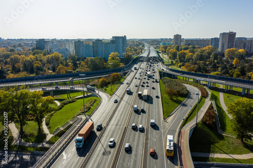 Aerial shot of  big freeway intersection in Warsaw, traffic going fast through many road flyovers. Poland. 30. October. 2019. Aerial view of a motorway with several traffic intersections.