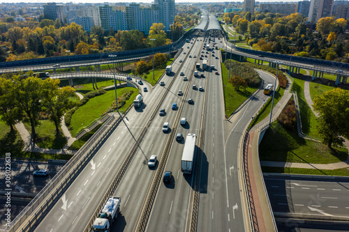 Aerial shot of  big freeway intersection in Warsaw, traffic going fast through many road flyovers. Poland. 30. October. 2019. Aerial view of a motorway with several traffic intersections.