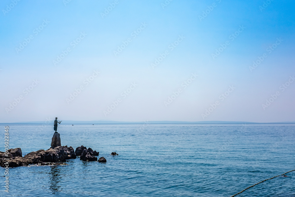 Famous bay statue of a girl holding a seagull in Town of Opatija, Kvarner bay of Croatia