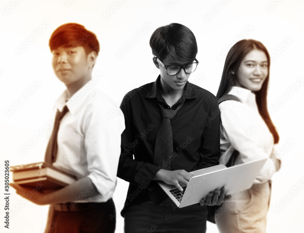 In selective focus of young teenager using laptop ,standing at the middle of blurred man and woman,new generation,working aholic feeling,blurry light around In selective focus of young teenager using laptop ,standing at the middle of blurred man and woman,new generation,working aholic feeling,blurry light around