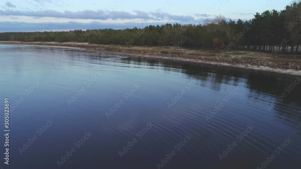 span along the riverbank with a beautiful forest and reeds. clear water and picturesque stones on the shore span along the riverbank with a beautiful forest and reeds. clear water and picturesque stones on the shore