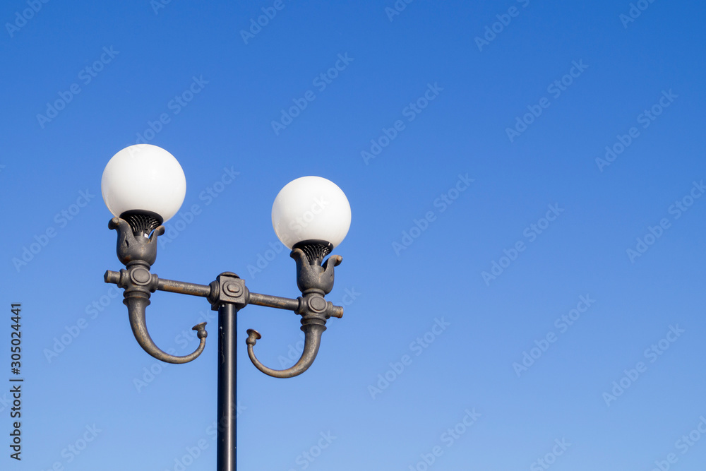 forged street lamps against the sky forged street lamps against the sky