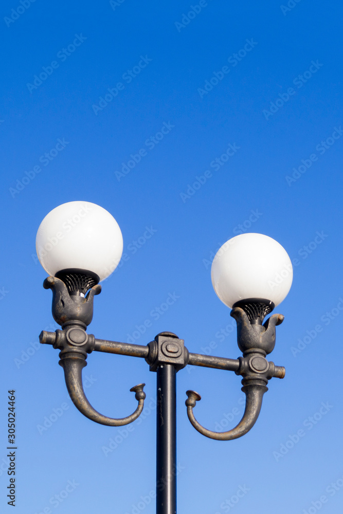 forged street lamps against the sky forged street lamps against the sky