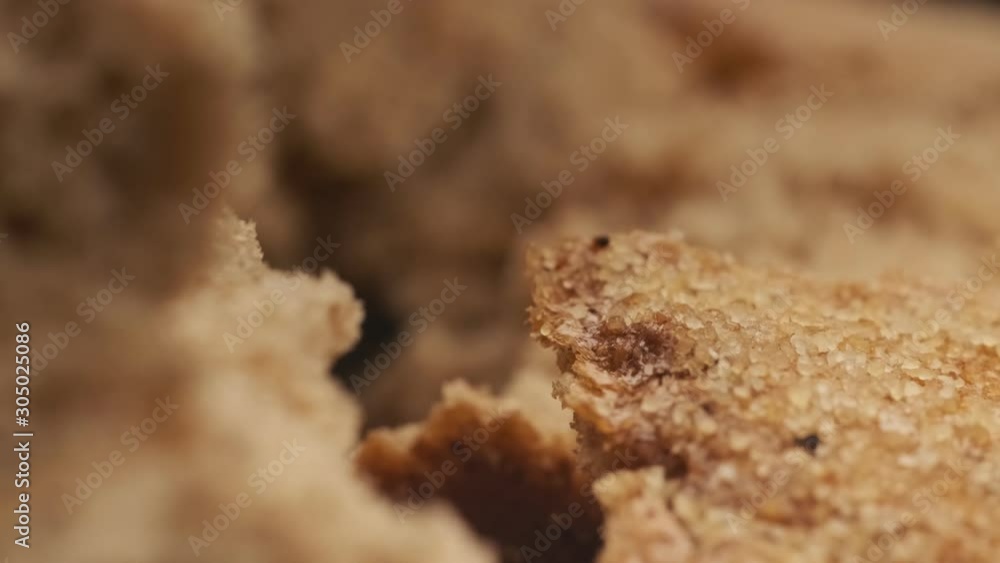 Camera move through breaking fresh bread. Organic food and bakery concept. Wholegrain bread. Super close up view in 4k, UHD Camera move through breaking fresh bread. Organic food and bakery concept. Wholegrain bread. Super close up view in 4k, UHD