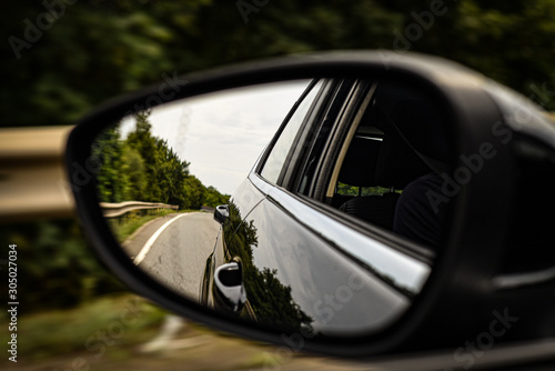 Car wing mirror reflection driving.  © Ollie