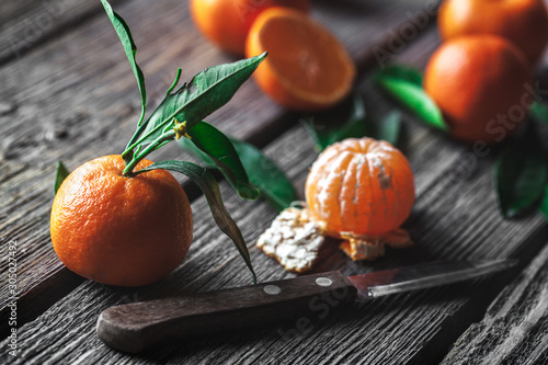 tangerines with a knife on a wooden background. Healthy food. Fruit photo