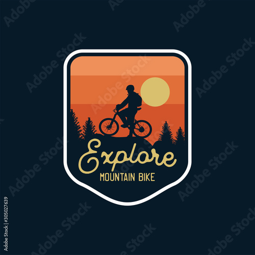 explore mountain bike badge silhouette sunset background. logo patch