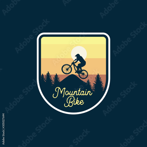 mountain bike badge jump silhouette yellow sky background. logo sign patch design